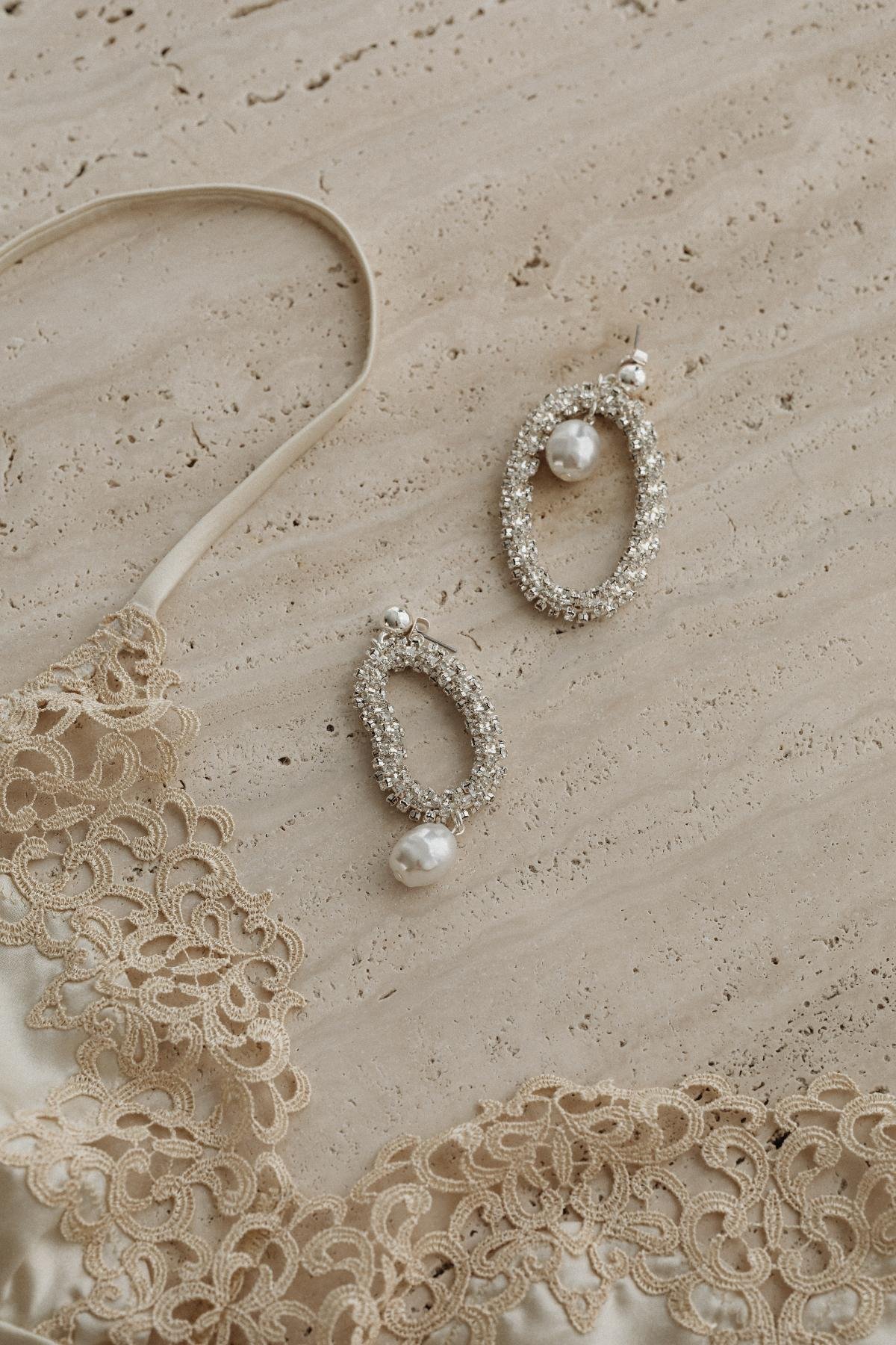 kaboompics satin light beige bra trimmed with lace silver earrings with zircons and pearls 31788